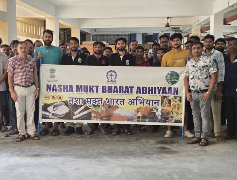 Students and faculty holding a Nasha Mukt Bharat Abhiyaan banner at LBS Hall